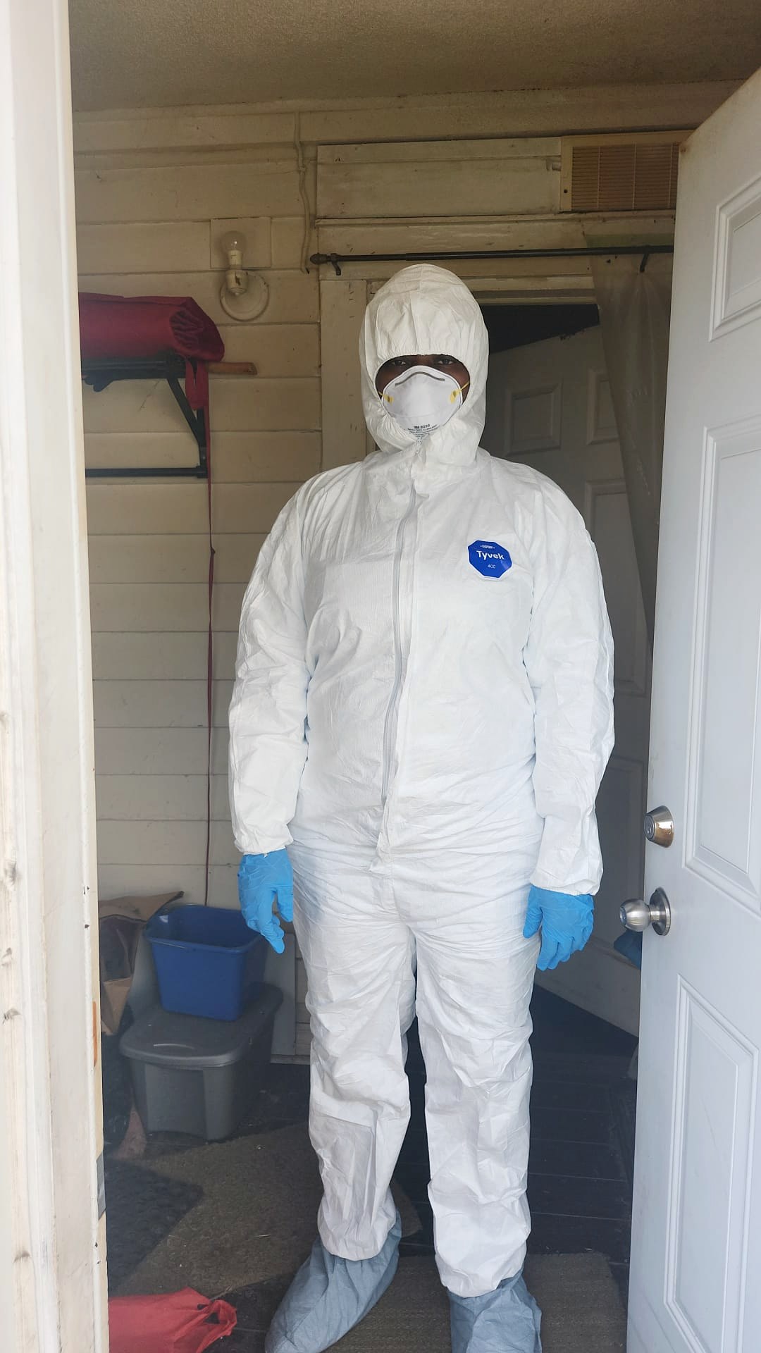 Lumina cleaner in full protective suit ready for a heavy-duty deep clean