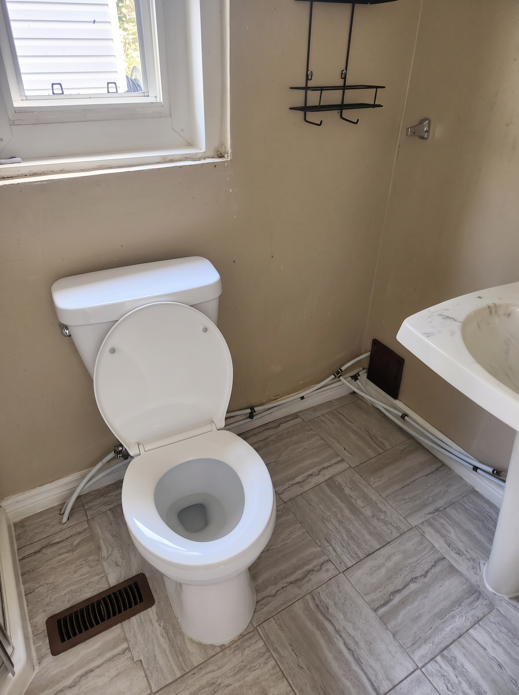 Same bathroom with sparkling toilet and floor after deep cleaning