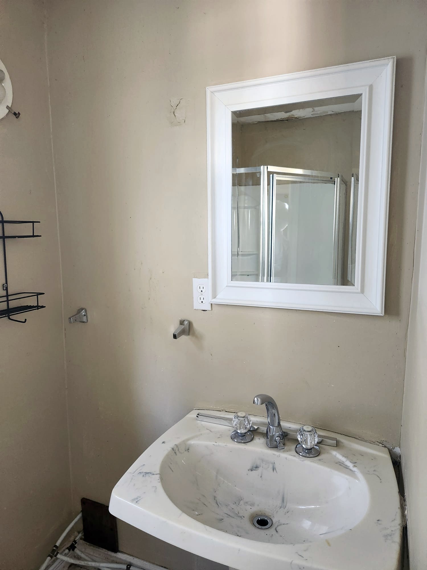 Stained bathroom sink and mirror before cleaning